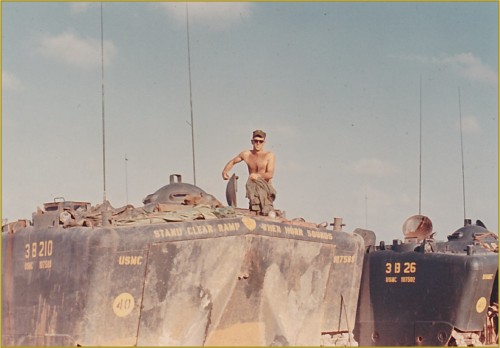 Cpl Joe McNeil kneeling on an Amtrac